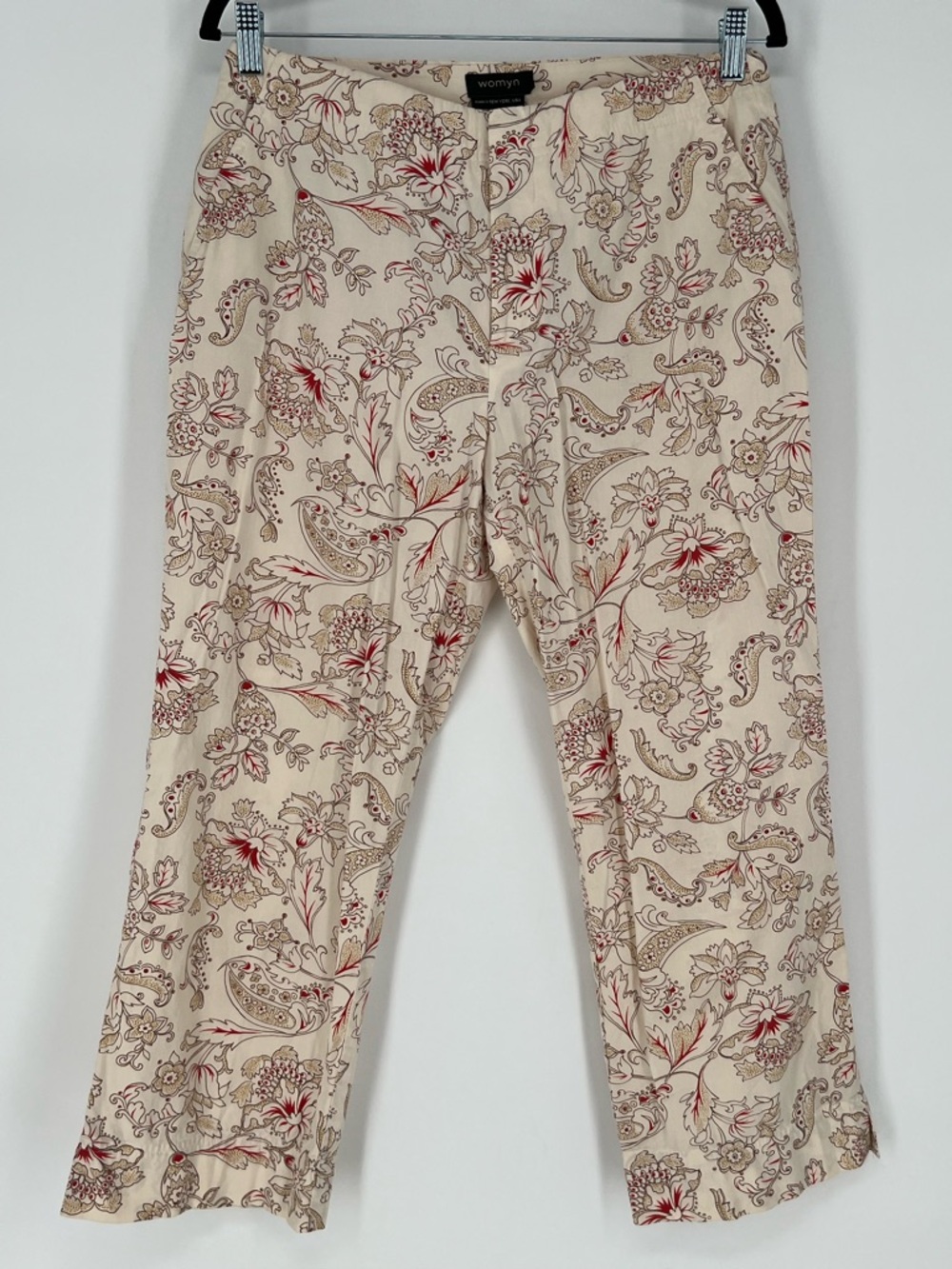Womyn brand pants in cream fabric‎ with a red and brown paisley floral pattern.